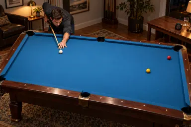 Anonymous player with one white cue ball and two ordinary object balls on an unmarked pool table