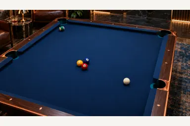 Original still of three loosely grouped object balls, a separate cue ball and an insurance ball on blue pool cloth